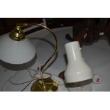 A white angle light and similar brass glass shade desk lamp