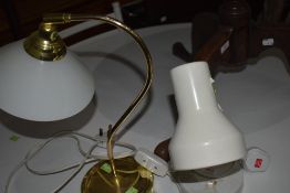 A white angle light and similar brass glass shade desk lamp