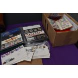 A box containing GB First Day Covers, an Album of Presentation Packs and five Albums of World Stamps