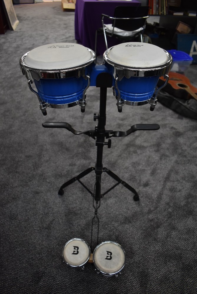 Two pairs of bongos, one having stand