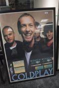 A framed and glazed concert poster and ticket stubbs for Coldplay