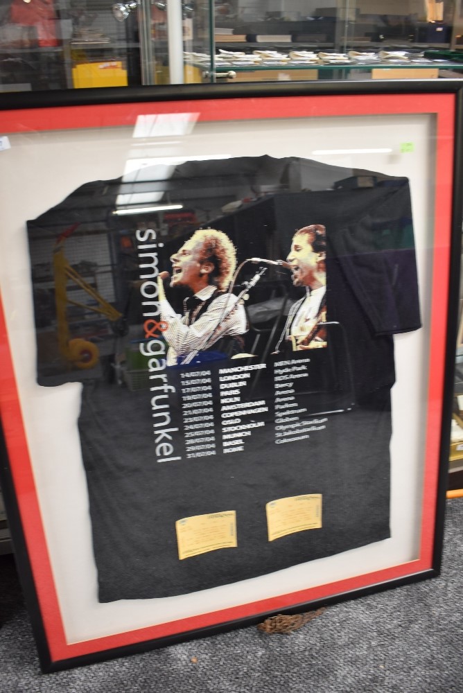 A framed and glazed concert t shirt and gig tickets for Simon and Garfunkle from the 2004 tour