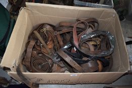 A box of vintage leather gun case straps and cartridge magazine straps