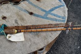 A Vintage split cane 3 piece fishing rod with spare tip.