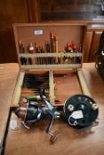 Fishing float box and contents with giant spinning reel and paramount fly reel.