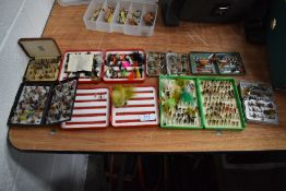 A large selection of fishing flies in metal and plastic fly boxes.