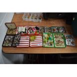 A large selection of fishing flies in metal and plastic fly boxes.