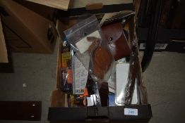 A box of miscellaneous items including knife sheaths, 12 gauge barrel plugs etc