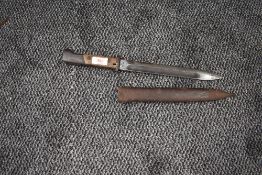 A Polish Mauser Bayonet, blade marked FB Radom 1939 with Polish Eagle symbol, with metal scabbard,