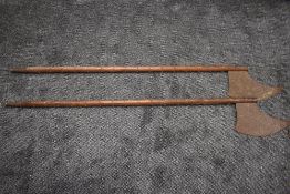 A pair of reproduction medieval metal studded Long Handled Executioners Axes overall length 160cm