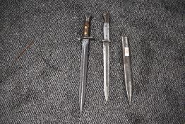 A German Ersatz bayonet having metal grip and metal scabbard, Soligen mark to blade, scabbard marked