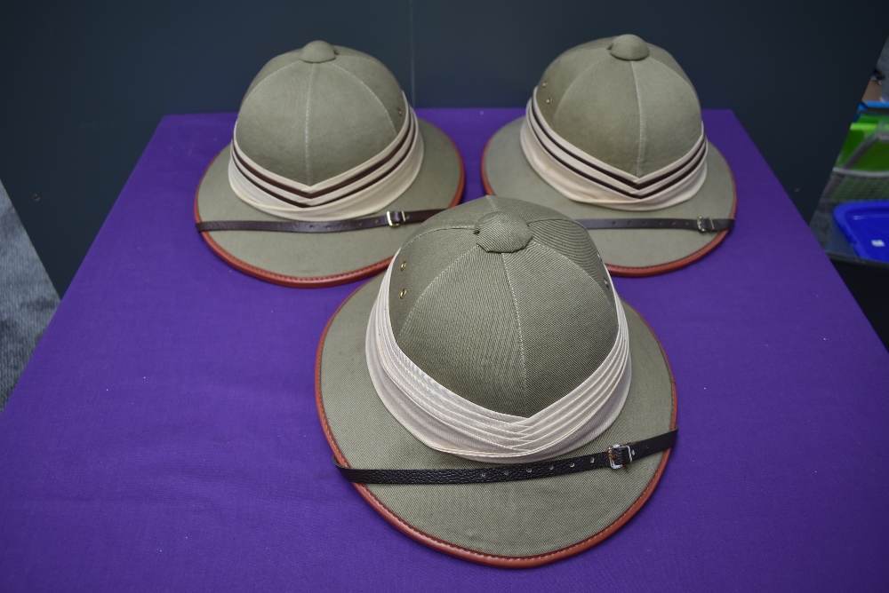 Three Kharki Pith Helmets, size 57 x2 and 58 all with cream and brown band, all with chin straps
