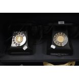 A pair of traditional bakelite telephones one having name badge for Call Exchange