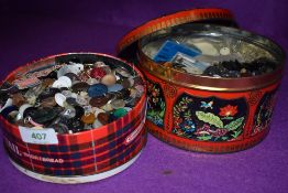 Two tins of vintage dress makers or haberdashery buttons and fasteners
