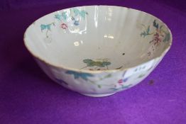 An antique Chinese porcelain punch or slop bowl having hand decorated naturalistic design