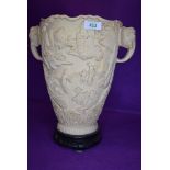 A reproduction ivory style twin handle vase having elephant motif and landscape relief