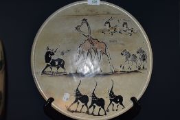 A large hand carved African stone bowl having elephant giraffe and rhino imagery