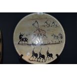 A large hand carved African stone bowl having elephant giraffe and rhino imagery