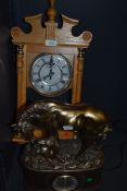 A quartz mantle clock of a horse and foal in a bronze effect and a wooden cased clock