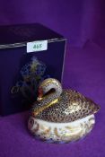 A ceramic Royal Crown Derby paper weight or figure of a Black Swan having gold stopper and box