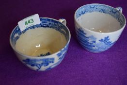 Two early English transfer tea cups one being tin glazed with unusual scene fisherman and water
