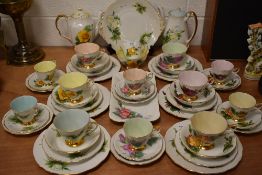 A selection of harlequin tea cups and saucer trios by Royal Standard and Paragon