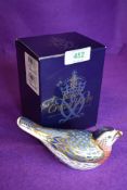 A ceramic Royal Crown Derby paper weight or figure of a Bluebird having gold stopper and box