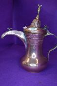 An antique coffee or chocolate pot having copper body with brass fitments bearing Arabic style mark