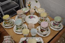 A selection of tea cup and saucer trios by Royal Standard in a Harlequin design