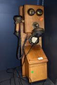 A reproduction wall mounted telephone made by Astral