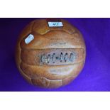 A vintage leather bound and stitched football by Mark Cross