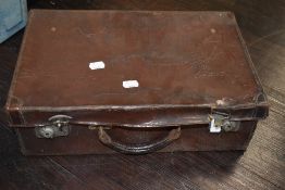 A vintage small leather bound suitcase