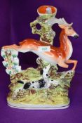 A Staffordshire flat back spill vase depicting leaping dog and deer.