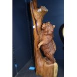 A hand carved bear and branch figure in a Black Forrest style