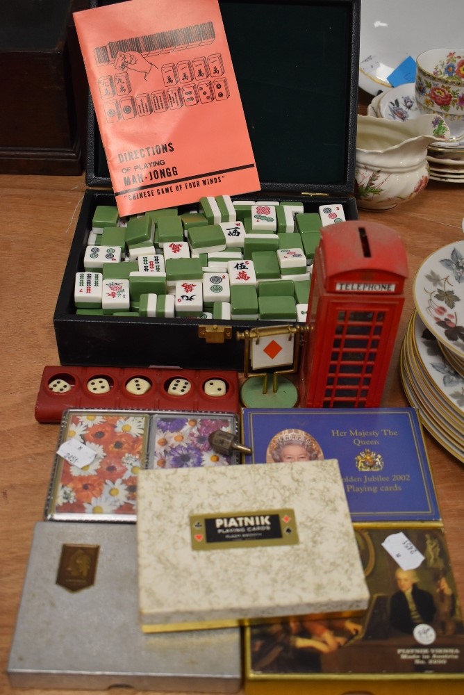 A selection of card games and counters including Mahjong set