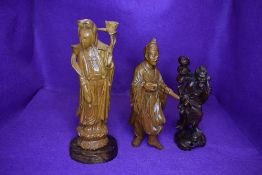 Three hand carved Chinese figures including lady atop lotus leaf