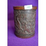 A hand carved Chinese bamboo brush pot depicting man of horse back 17cm tall