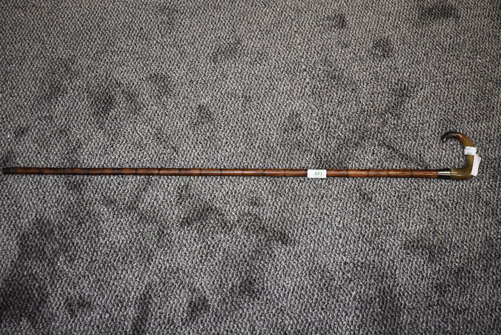 A late Victorian bamboo shafted walking cane having animal horn handle and silver knopp