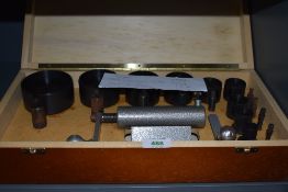 A watch clock or chronographers coil or mainspring winder set with various sizes and complete