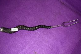 An antique toasting fork having African animal horn handle grip