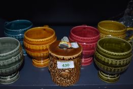 A set of harlequin ceramic goblets and similar honey jar