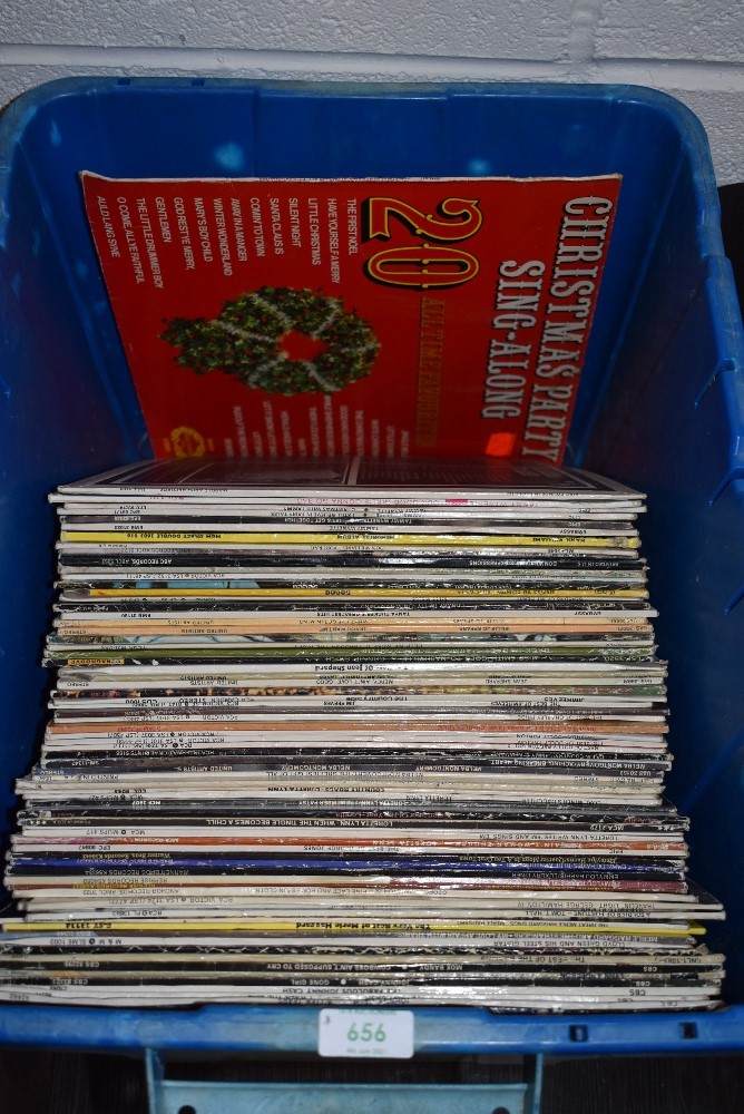 A box full of vinyl records predominantly country interest.