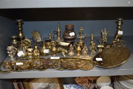 A selection of brass wares including bells strainer and horse brasses