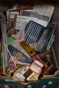 A box full of vintage and antique haberdashery including early knitting and crotchet patterns,