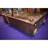 A vintage underbed or similar bedding box, having wooden wheels