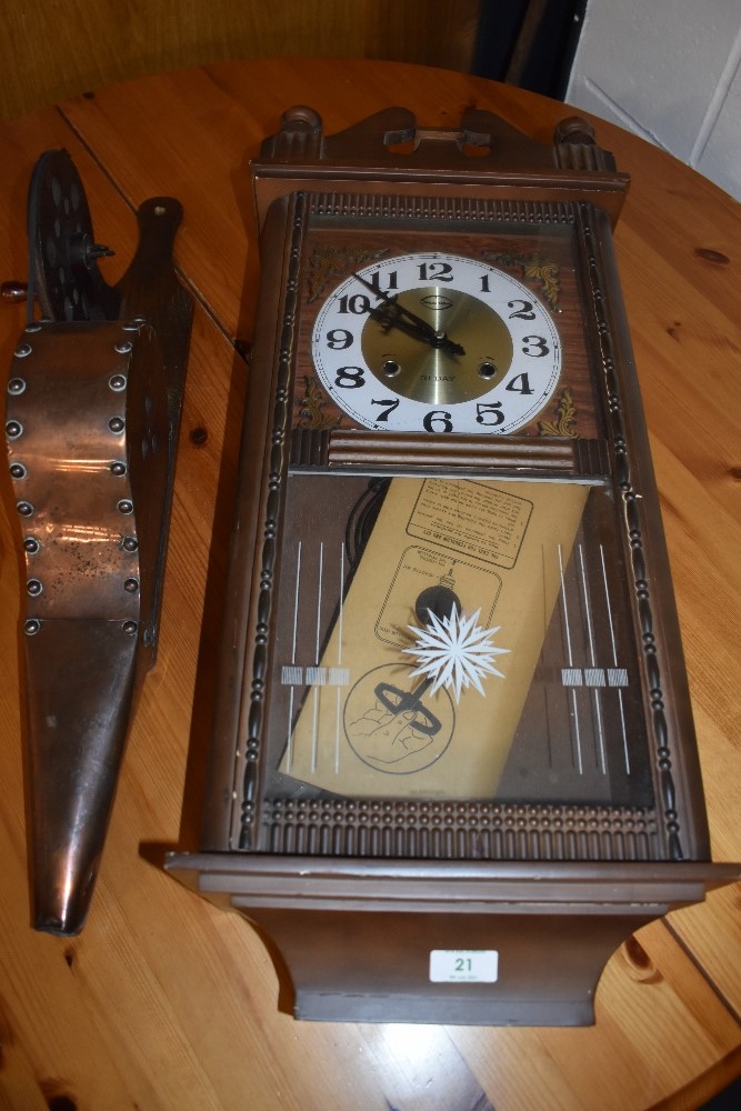 A traditional set of oak and copper bellows and a reproduction wall clock
