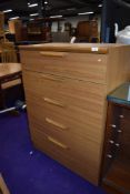 A laminate chest of five drawers