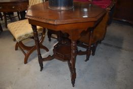 A Victorian mahogany occasional table having octagonal top and galleried undertier