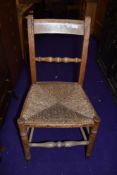 A 19th Century rush seated farmhouse style kitchen chair