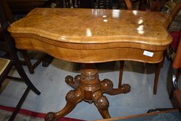 A fold out card table possibly late Victorian having carved base with Burr veneer decorated top